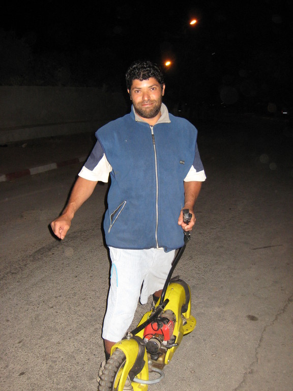 011-aziz-on-motor-skateboard.JPG